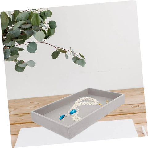 Three Piece Multi Grid Jewelry Organizer Trays Featuring Earring Stands Necklace Display Plates And Soft Velvet Ring Inserts To Make Sorting Your Bling A Breeze For Home Or Showroom Use, showing a grey tray with pearls and blue gem.