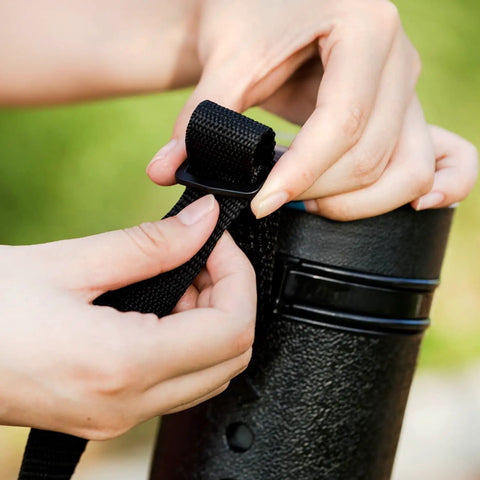 Hands adjusting strap on Extendable Poster Storage Tube With Strap Hits Different shielding rolled posters, ensuring secure transport.