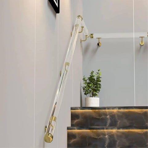 Custom Clear Acrylic Stair Handrail With Premium Gold Wall Brackets For Heavy Duty Indoor Exterior Support Featuring A Kickass Non Slip Grip And No Sweat Installation installed next to marble steps.