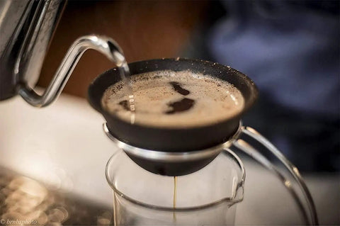 Pouring hot water through Prime Pick Japanese Ceramic Coffee Dripper With Reusable Filter for brewed coffee.