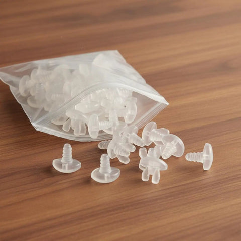 Premium Drapery Track Stoppers Keep Your Curtains Locked Down Totally Slip Free Tough Snap Install For Narrow Window Channels Perfect For Rental Turnovers And Quick Home Fixes, pack of clear plastic curtain glides on a wooden surface.
