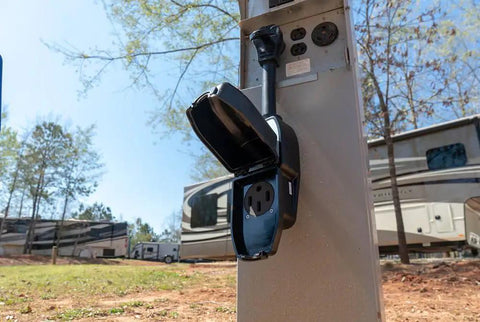 RV site power pedestal with Portable 50A Surge Guard Power Protector With LED Fault Readout built tough brass receptacles in use