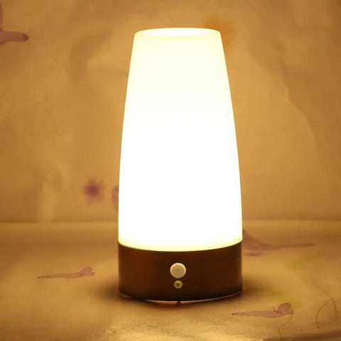 Retro LED Night Light With PIR Motion Sensor, Battery Powered Round Lamp glowing in warm light, ideal for indoor use.