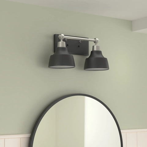 Bramlett Brushed Nickel Two Light Bath And Vanity Fixture With Matte Black Shades And Back Plate above round mirror