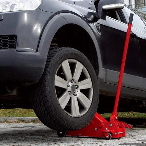 Heavy Duty Hydraulic Floor Jack With 7000 Lb Capacity lifting a car tire, showcasing red steel base and quick lift piston.