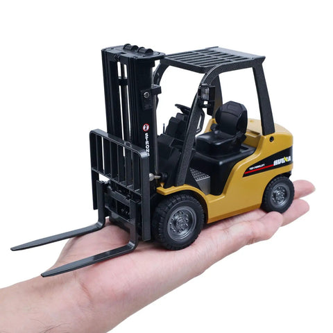 Mini Warehouse RC Forklift Model 9925 With Realistic Light And Sound Effects Precise Steering Lift Lower Function Plus Remote Control Operation For Indoor Play held in a hand.