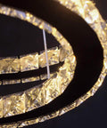 Close-up of Modern 4-Ring Crystal LED Chandelier with K9 crystals and stainless steel, warm white 2700-3500K lighting.