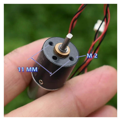 Close-up of 16mm 1215 Planetary Gearbox For DC Motors held in hand, showing 11mm measurements and wires, for DIY robotics projects.