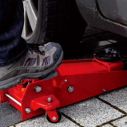 Heavy Duty Hydraulic Floor Jack With 7000 Lb Capacity being activated with a foot for quick lift during car maintenance.