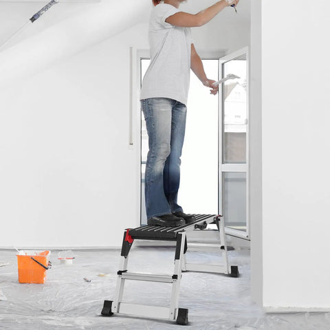 Person using Beast Mode Foldable Aluminum Work Platform Drywall Stool Ladder for wall painting in a bright room.