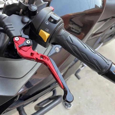 Top Tier Folding Brake And Clutch Levers For Benelli BN302S with adjustable red and black levers on motorcycle handlebars.