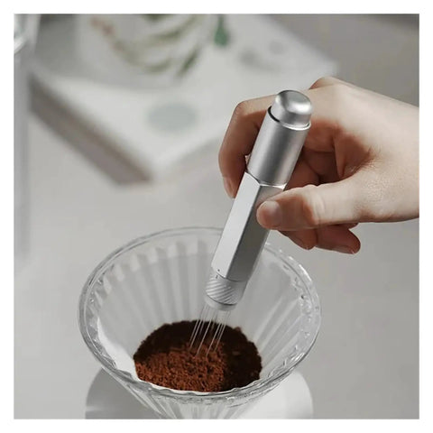 Top Shelf Telescopic WDT Tool For Espresso Distribution With 8 Bonus Stainless Steel Needles Adjustable Barista Stirrer in use stirring coffee grounds.