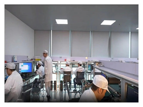 Workers in a laboratory setting working on electronics, focusing on testing and calibration of devices.
