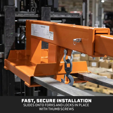 Built Tough Fork Mounted Telescoping Jib Boom Crane With 5500 LB Lifting Power And Sweet 31 To 79 Inch Reach close-up of orange jib boom attached to forklift forks.