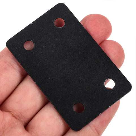 Close-up of a Six Pack Stainless Steel Straight Mending Plate For Wood Furniture Repair With Black Finish, held in hand