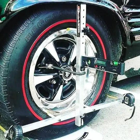 Slick Portable Wheel Alignment Kit For 13 To 18 Inch Tires on a black tire, checking caster and camber angles, auto tool setup.