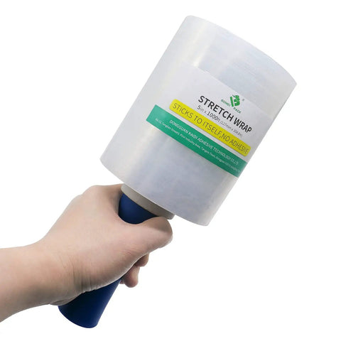 Hand holding Mini Clear Stretch Wrap Film 5 Inch By 1000 Feet 4 Pack With Easy Grip Handle, 80 Gauge Heavy Duty Pallet Wrap