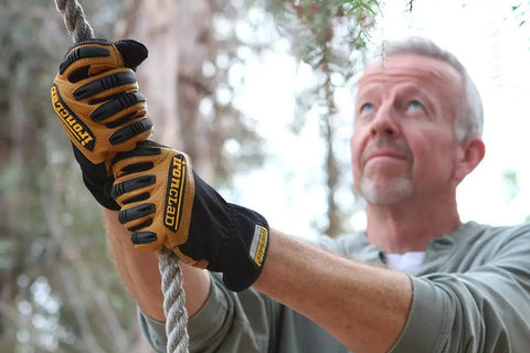 Man climbing rope wearing Rugged Rolltop Seamless Fingertips Leather Work Gloves With Kevlar Reinforcements For Maximum Dexterity