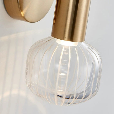 Close-up of Snazzy Slick Led Wall Sconces For Modern Home Refresh Up And Down Adjustable Glass Shade with gold accent.