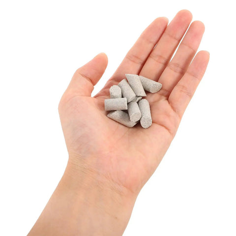 Hand holding Cylinder Tumble Media For Silicon Carbide Polishing Pellets 440g, gray cylinders for vibratory tumbling