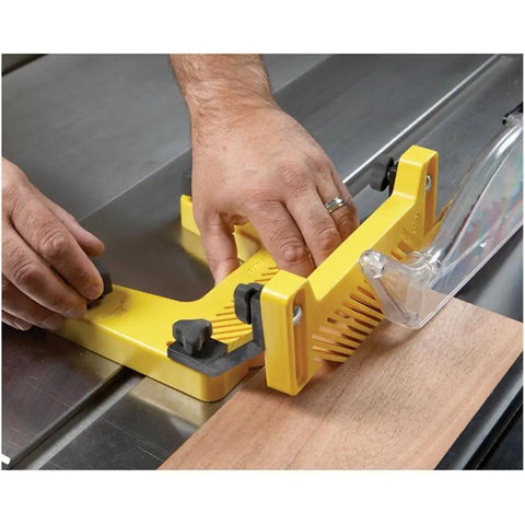 Hands adjusting Pro Table Woodworking Featherboard with Triple Holding Power for vertical use with magnetic clamp on table saw.