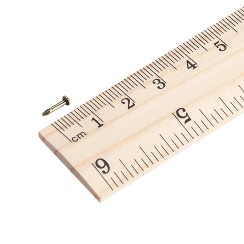 Top Shelf Solid Tiny Nails For Wood Crafting And Picture Frames Copper Plated Carbon Steel Fasteners next to a ruler measuring 8mm size.