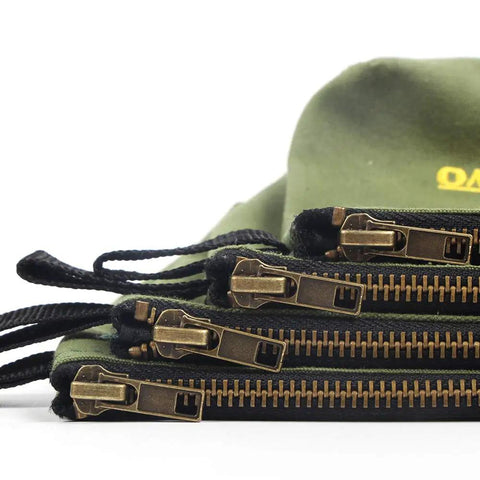 Close-up of brass zippers on Four Pack Heavy Duty Canvas Tool Pouches With Brass Zippers Water Resistant Twenty Ounce Army Green Flat Bottom.