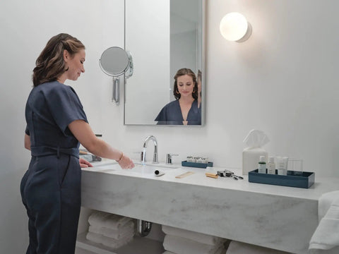 Woman using Flute High Arc Bathroom Faucet, 3-Hole 6-16 Inch Installation, WaterSense Labeled, Chrome Finish, in modern bathroom