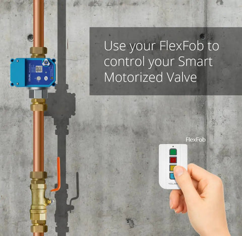 Pro Grade Smart Motorized Stainless Steel Ball Valve With LoRa Wireless Control and remote in hand against concrete wall