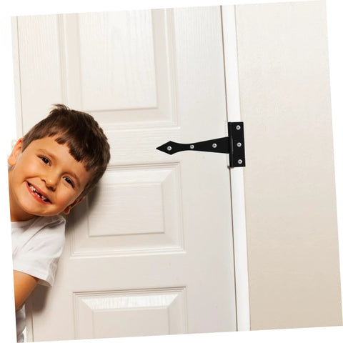 Child peeking around a door with heavy duty cabinet hinges installed for secure support and easy movement in home settings.