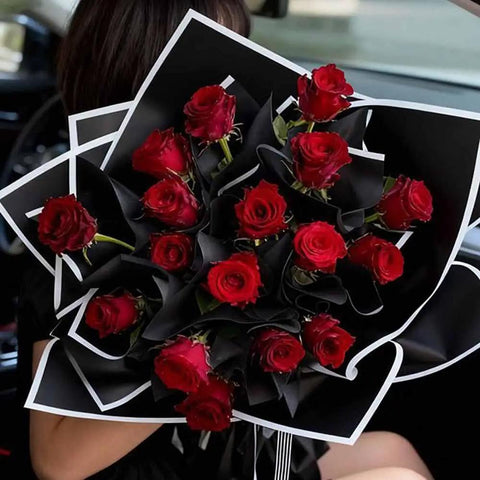 Bouquet wrapped in waterproof black and white floral wrapping paper sheets 22.83 inch square for gift packaging.
