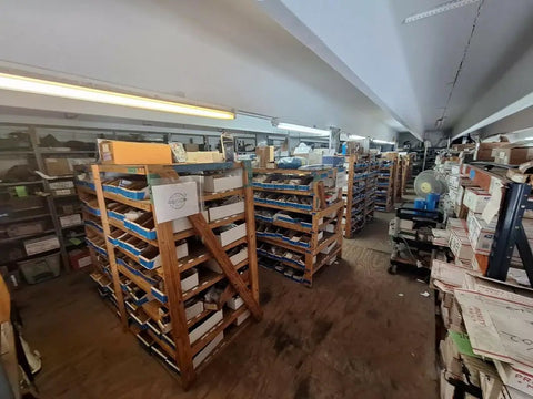 Warehouse interior showing shelves filled with marine equipment, related to Compact Joystick For M100 M200 Marine RayNet Network.