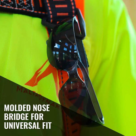 Tinted Safety Glasses 12 Pack ANSI Z87 Plus UV Eye Protection for Construction attached to high-visibility vest, focus on nose bridge.