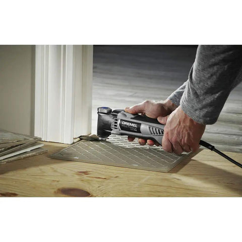 Pro Grade Corded Oscillating Multi Tool Kit 120V 3.5 Amp Power, Reconditioned, cutting flooring near doorway