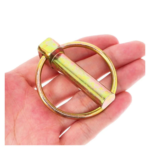 Hand holding one of the Eight-Piece O Shape Pin Heavy Duty Trailer Hitch Pin Kit 7/16 Inch By 1-3/4 Inch Pins for trucks and machinery