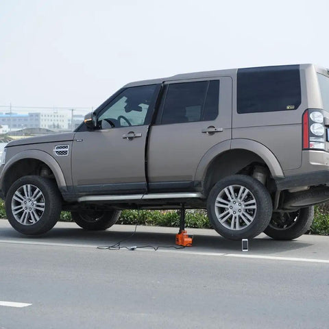 SUV lifted by Beefed Up Heavy Duty 15 Ton Electric Car Floor Jack With LED Light 12V DC Power For SUV RV Truck Van Sedan 33000 Lbs Lift