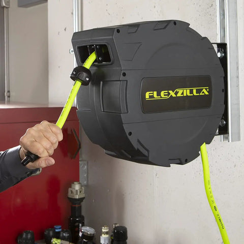 Person using Retractable Enclosed Plastic Air Hose Reel 3/8 Inch By 30 Foot Heavy Duty Lightweight Hybrid ZillaGreen with Auto Lock