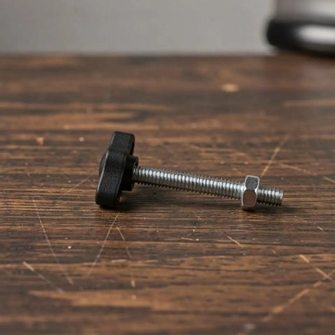 Dang Dependable M4 M5 M6 Tee Wing Bolt Knob Set on wooden surface, featuring black grip and silver threaded rod for tripod use.