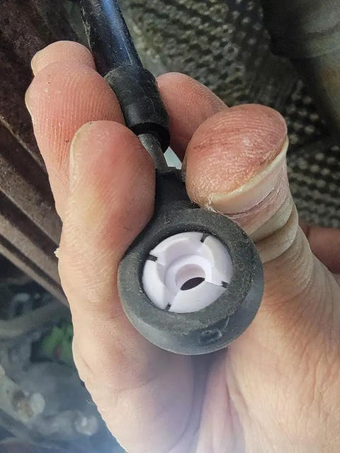 4 Pieces Automatic Transmission Shift Cable Bushing Repair Kit For A Ton Of Rides Including Dodge Avenger Caliber Dart Durango Grand Caravan Ram ProMaster Jeep And More Replacement Parts. Close-up of plastic shift cable bushing installed in transmission cable end.