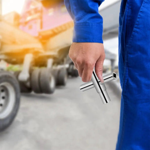 Heavy Duty 4 Way Sillcock Key Socket Wrench Set for Quick Faucet Valve Repairs held by worker in blue coverall.
