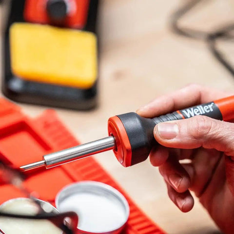 Hand holding 5 To 30 Watt Precision Soldering Iron Station With Adjustable Wattage And Integrated Safety Rest In Compact 120V Design