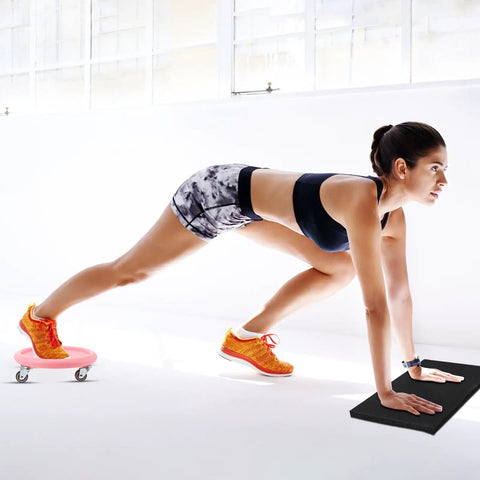 Woman using Four Wheel Ab Roller Exercise Wheel with Knee Mat for indoor core workout in bright workout space.