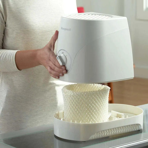 Person installing Humidifier Filter C Replacement Wick With Prefilter Layer into Honeywell humidifier for cleaner air