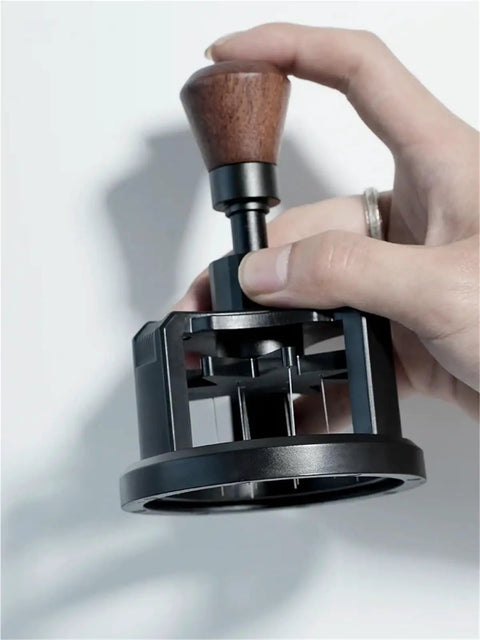 Premium Game Changer 58Mm Espresso Coffee Distributor With Magnetic Base And Precision Rotary Needles in hand, showcasing wooden handle.