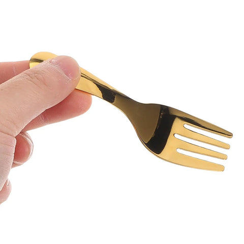 Hand holding gold fork from Portable Stainless Steel Camp Utensils Set With Pink Organizer Case For Outdoor Picnics Camping And Beach Trips