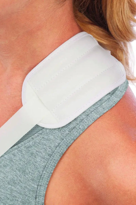 Close-up of Rock Solid Adjustable Arm Sling on gray tank top, featuring padded strap for shoulder support and quick recovery.