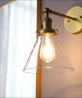 1 Light Wall Mount Sconce with Funnel Flared Clear Glass Shade in a retro-industrial style, antique gold finish