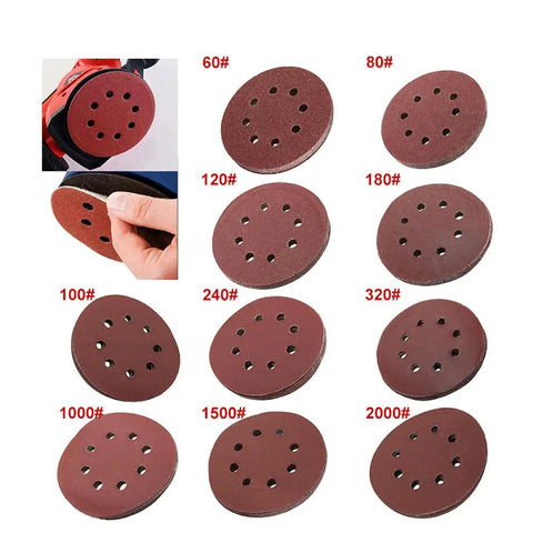 Premium 5 Inch Hook Loop Sanding Discs Featuring Eight Holes For Quick Dust Extraction And Killer Grip For Smooth As Butter Wood Metal Finishing The Real Deal Aluminum Oxide Abrasive Pads displayed in various grits.