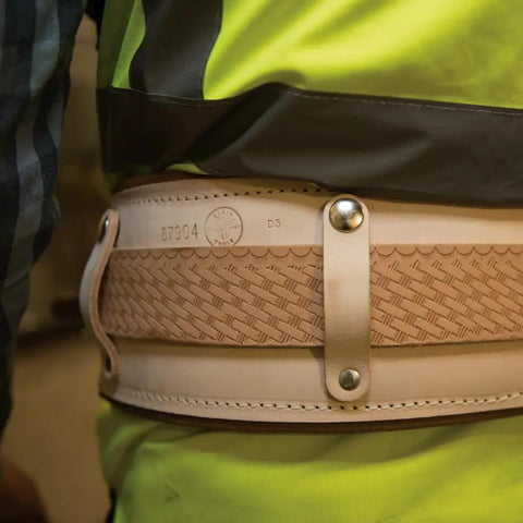 Person wearing 22-Inch Leather Cushion Belt Pad with Sponge-Padded Liner for Comfort, securely fastened with snap straps.