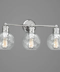 Three Light Coastal Vanity Light With Clear Glass Shades In Polished Nickel Finish illuminates modern beachy bathroom style
